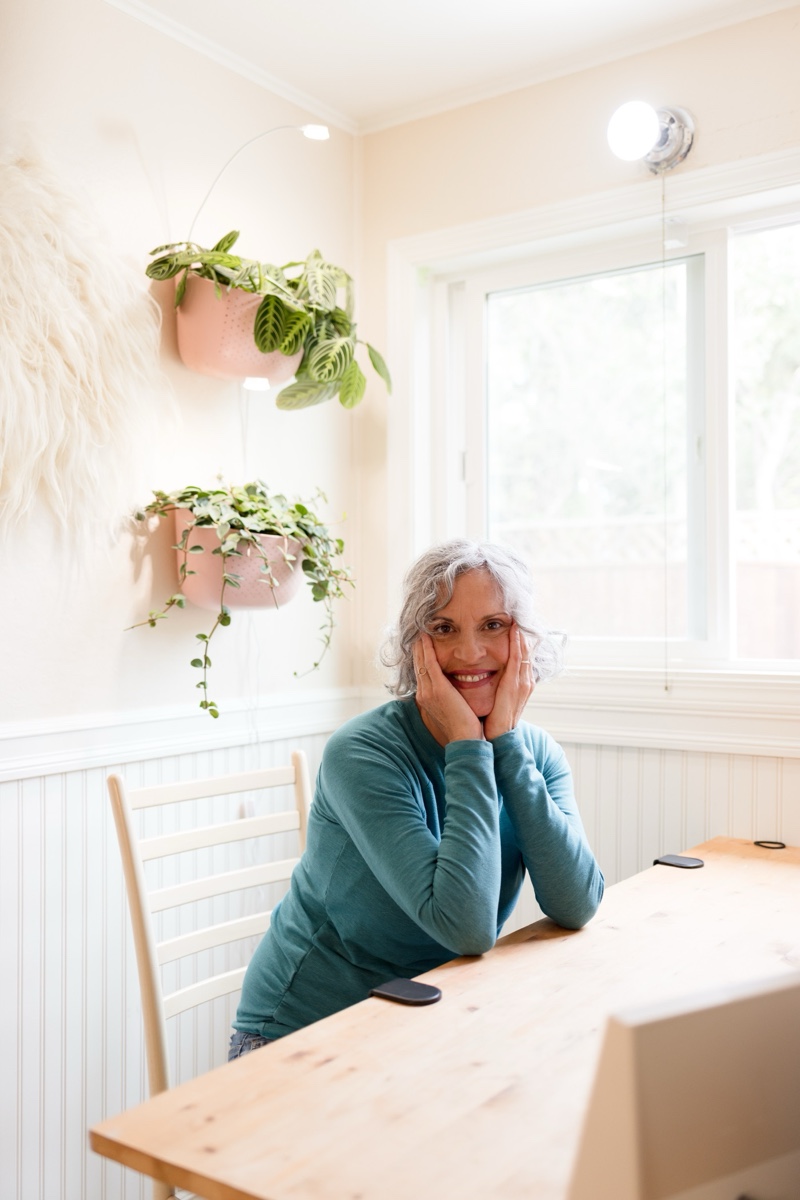 Cheryl Janis, founder of Cheryl Janis Agency, seated in her light-filled workspace